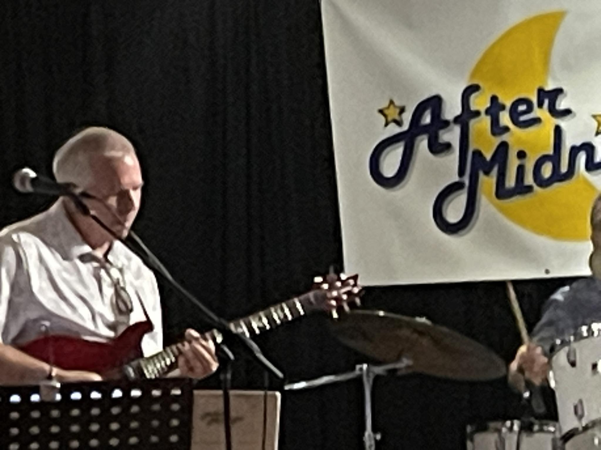 Jim on guitar on stage